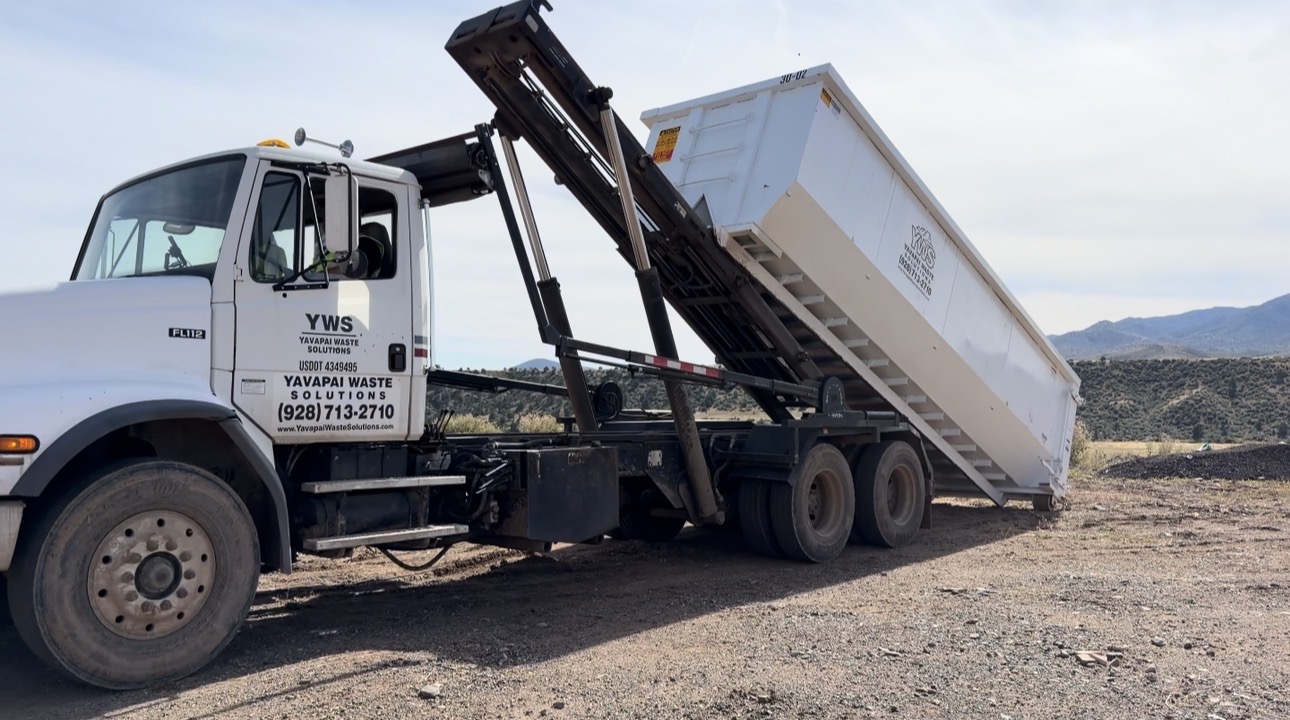 YWS roll-off truck delivering a branded 30-yard dumpster